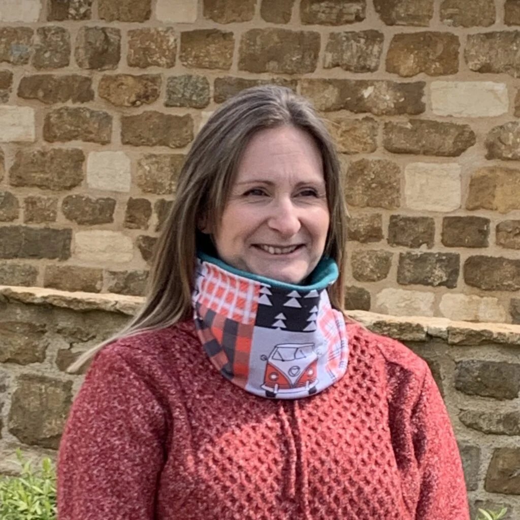 Lady wearing red and black camper van pattern neck warmer