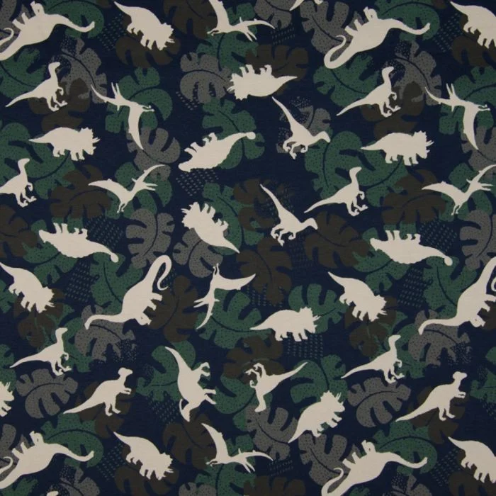 Jersey Material in green, grey and brown camouflage colours with grey dinosaurs, randomly placed. Include Triceratops, stegosaurus, T-rex and pterodactyl. Placed on a polystyrene head that has been decoupaged with pale white and yellow paper depicting various instruments, music and corsetry.